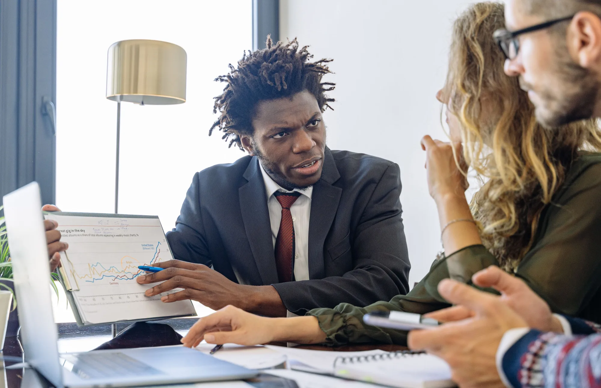 Berater und Kunden besprechen gemeinsam Unterlagen bei einem Investmentgespräch